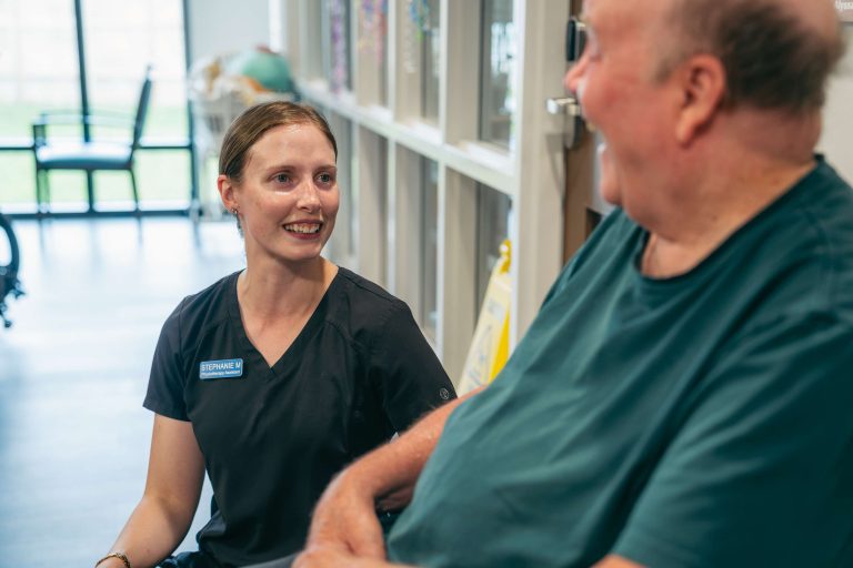 A staff member sharing a laugh with a resident